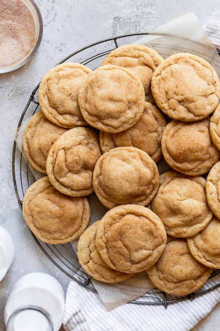 An overhead view of snickerdoodle cookies on a round cooling rack.