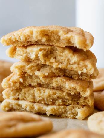 A stack of snickerdoodle cookies broken in half to show the interior texture.