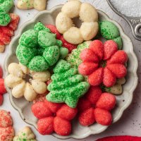 A pile of spritz cookies on a small plate.