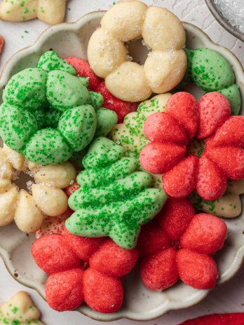 A pile of spritz cookies on a small plate.