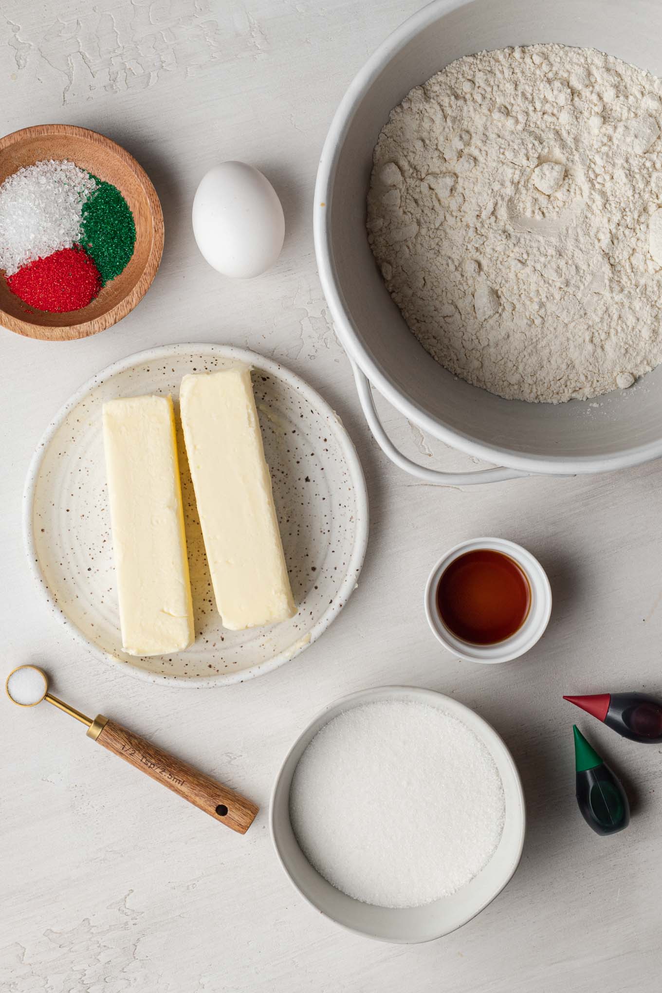 An overhead view of the ingredients needs to make spritz butter cookies. 