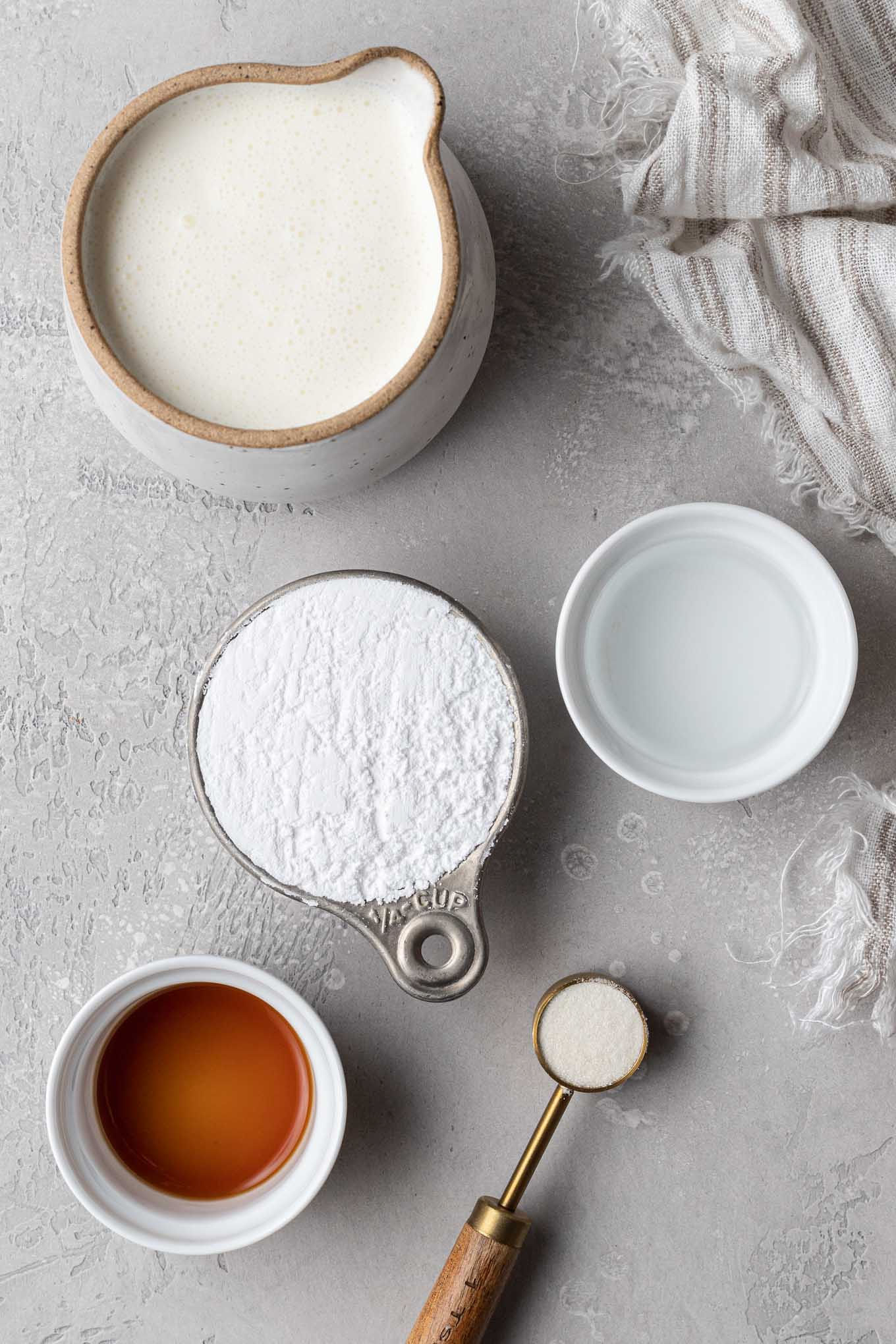 An overhead view of the ingredients needed for stabilizing whipping cream with gelatin. 