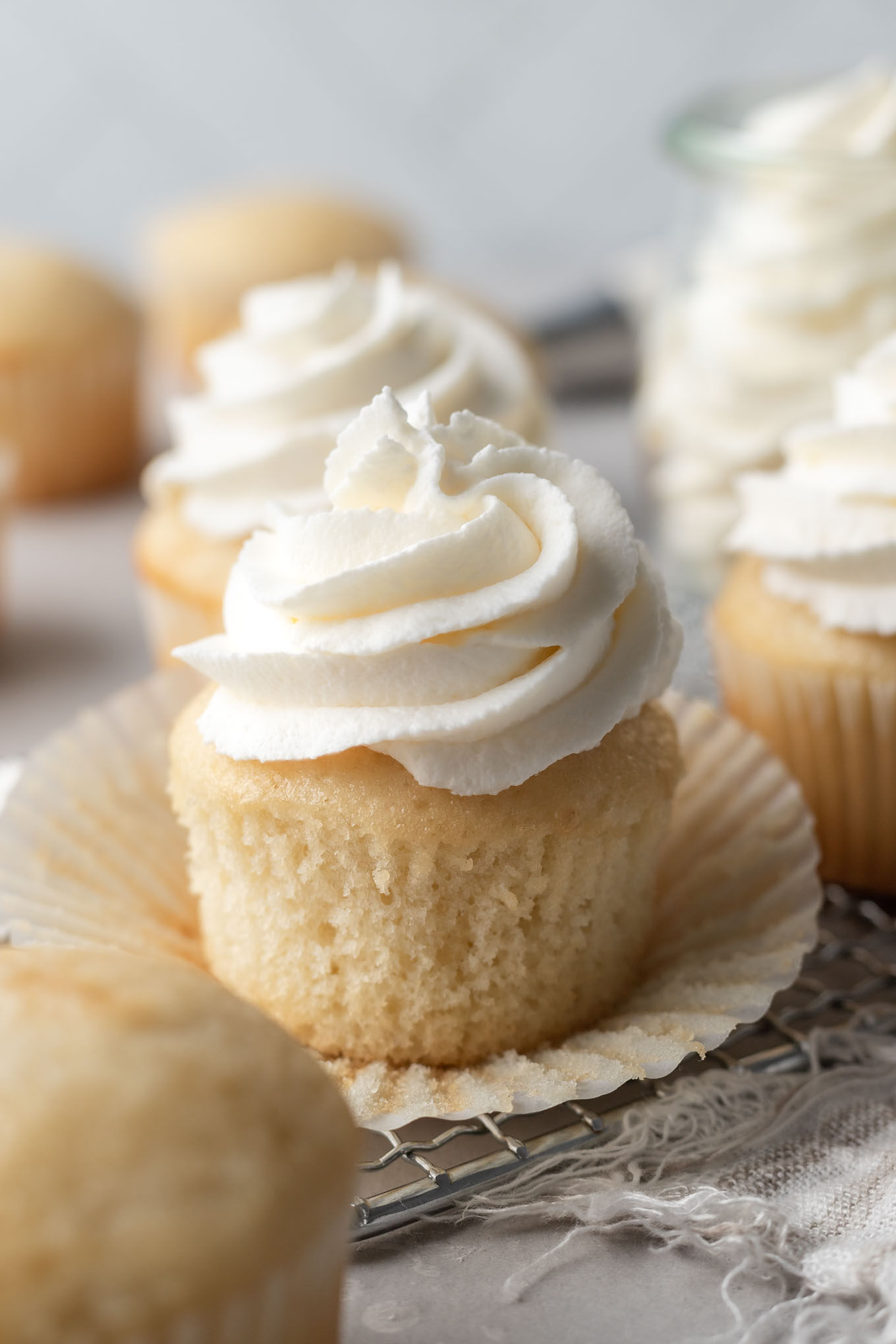 Vanilla cupcakes topped with stabilized whipped cream. 