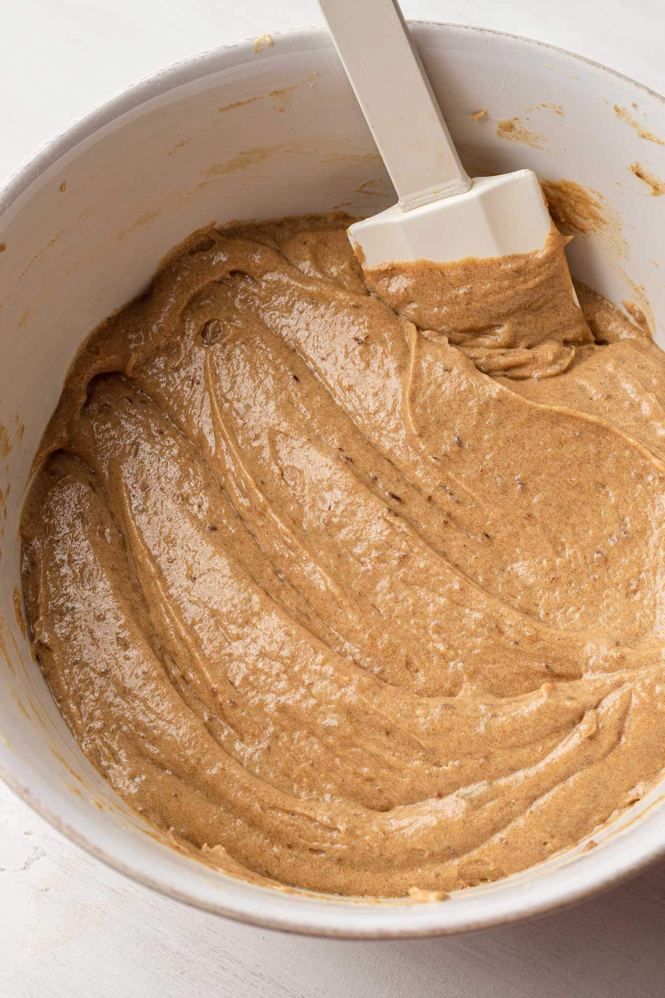 An overhead view of the cake batter fully mixed together in a white mixing bowl.