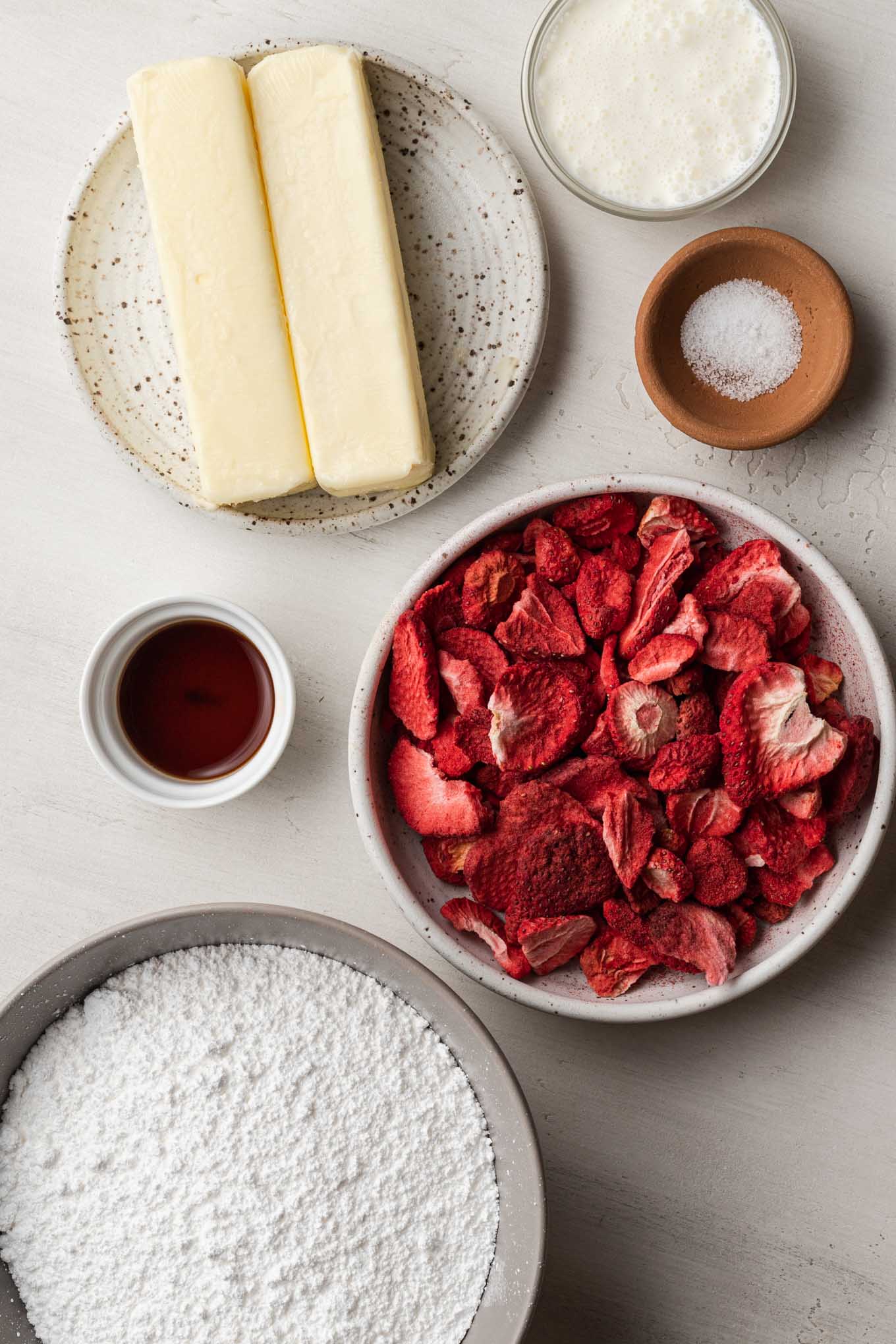 An overhead view of the ingredients needed to make strawberry buttercream. 