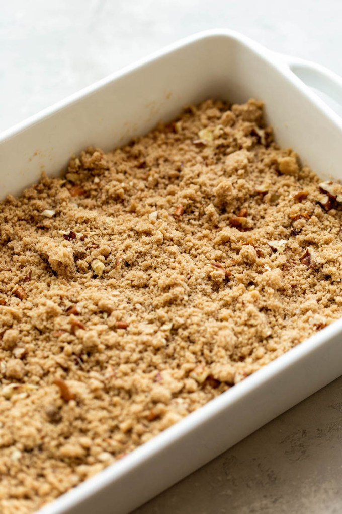 A sweet potato casserole topped with pecan streusel ready to go into the oven.