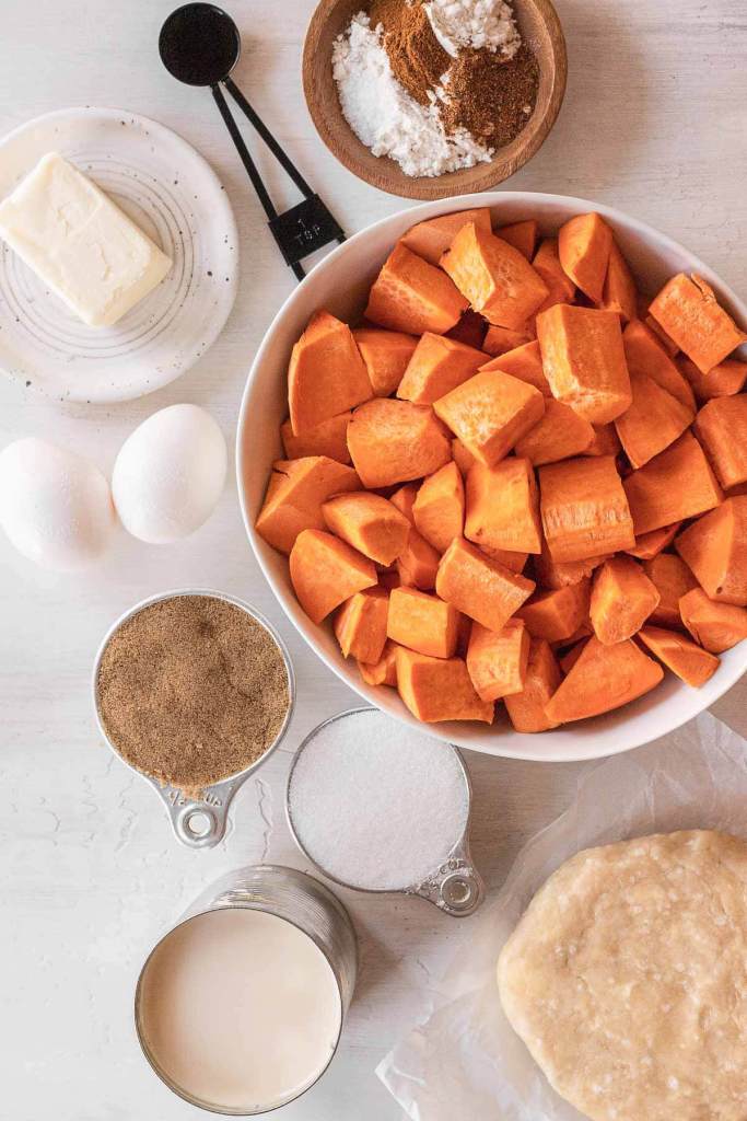 An overhead view of the ingredients needed to make a homemade sweet potato pie. 