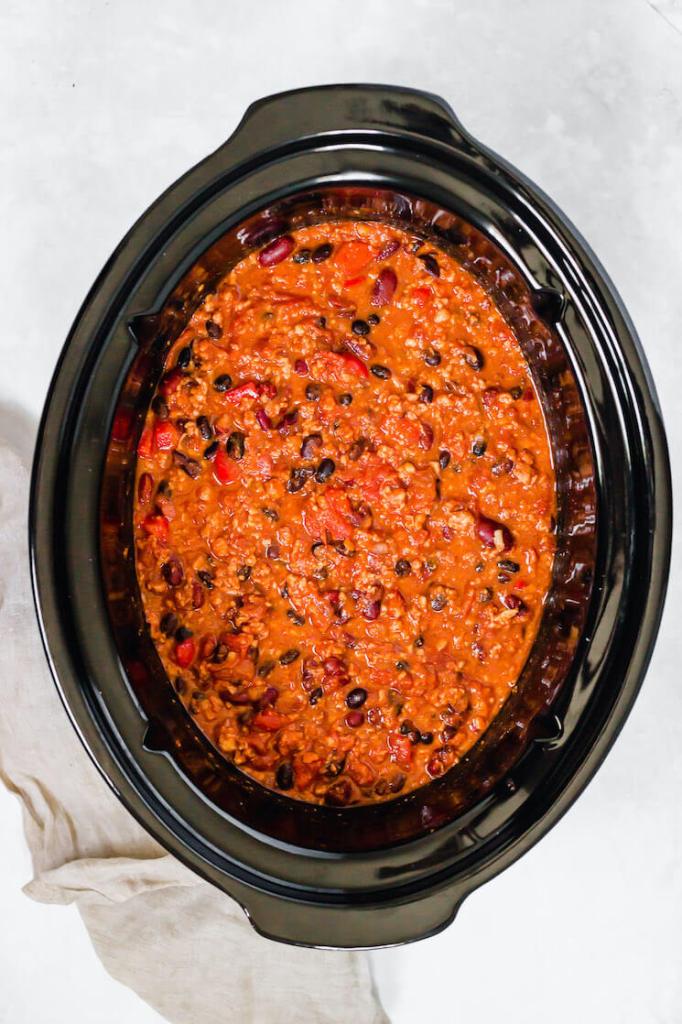 An overhead view of a crockpot filled with homemade turkey chili.