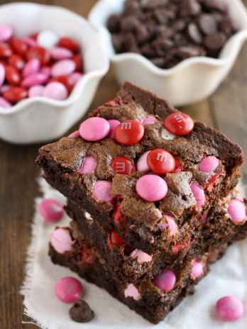 A stack of three Valentine brownies on a square of fabric.