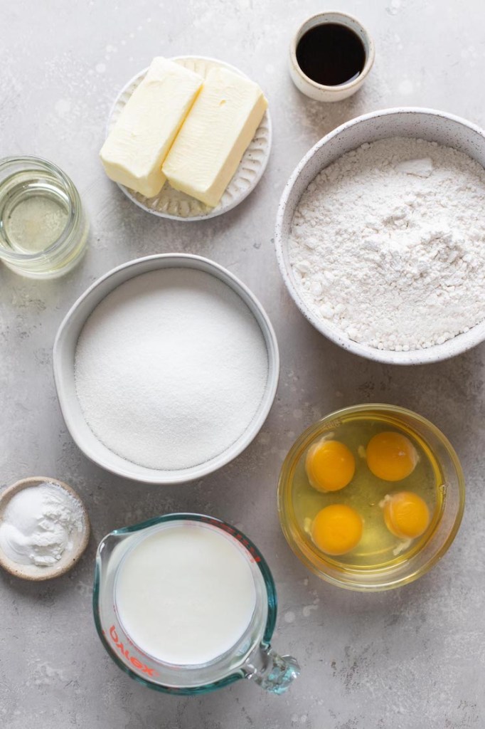 Overhead view of the ingredients needed to make a vanilla cake and vanilla frosting. 