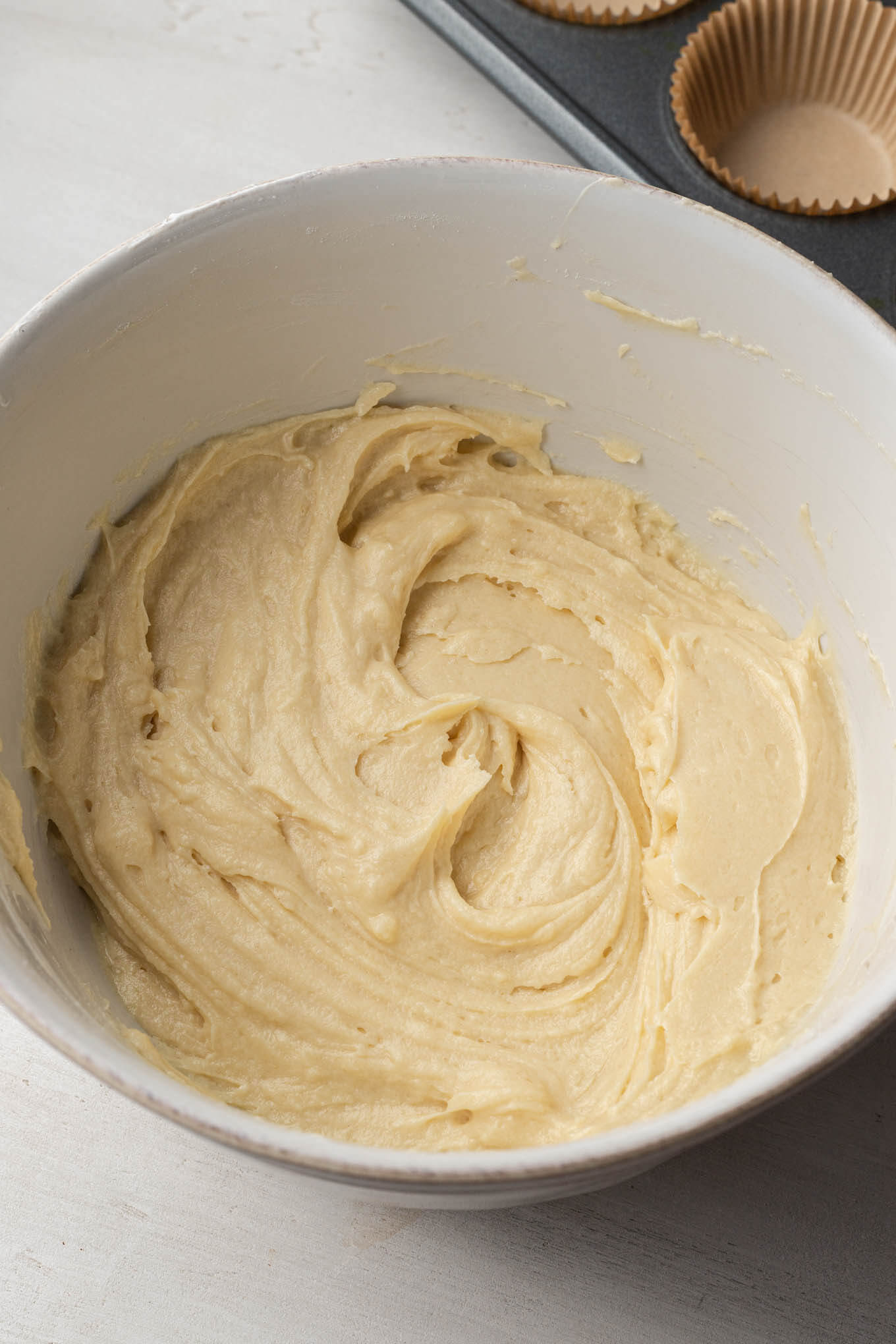 Vanilla cupcake batter in a mixing bowl.