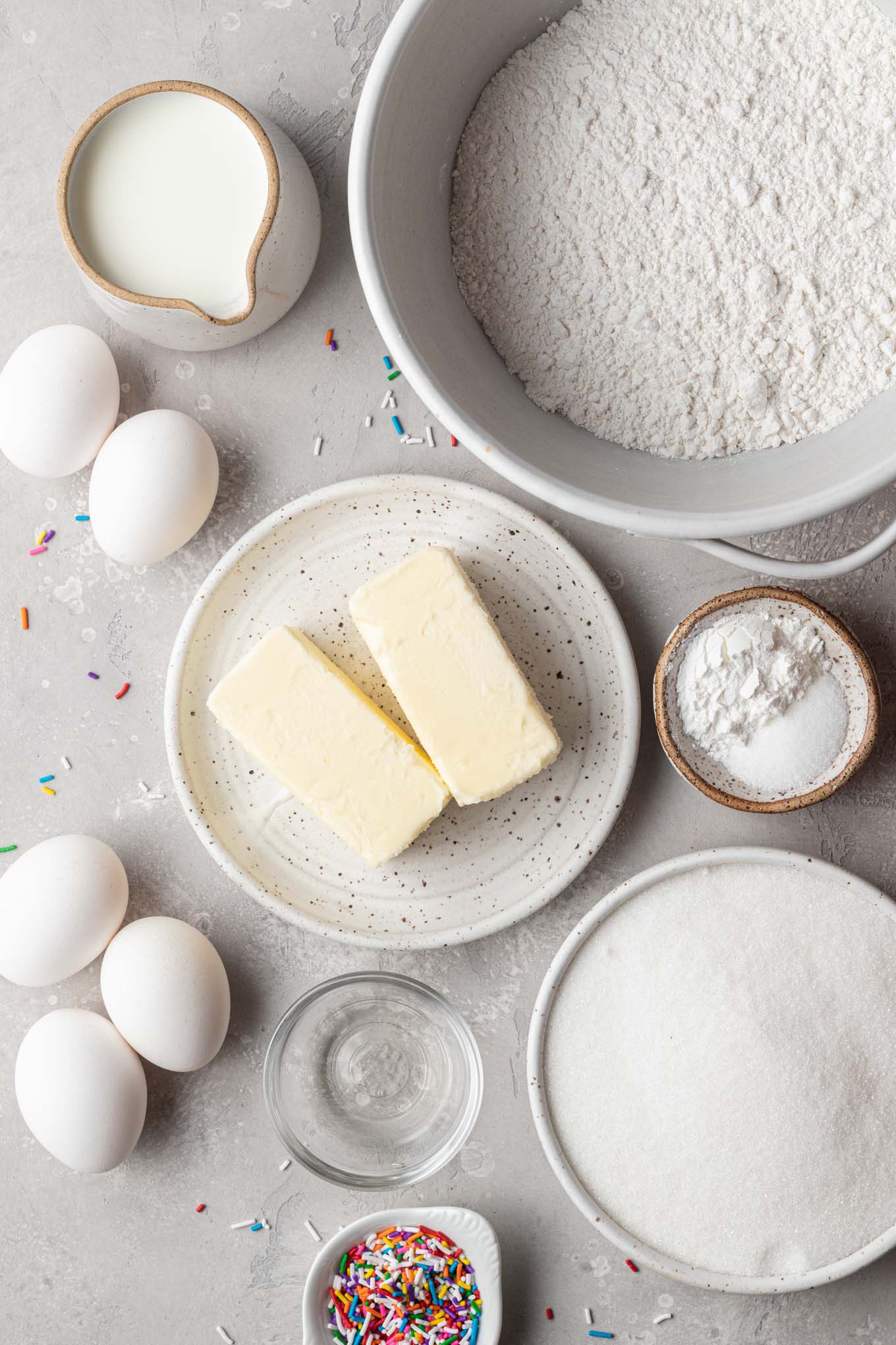 An overhead view of the ingredients needed to make a classic white cake recipe. 