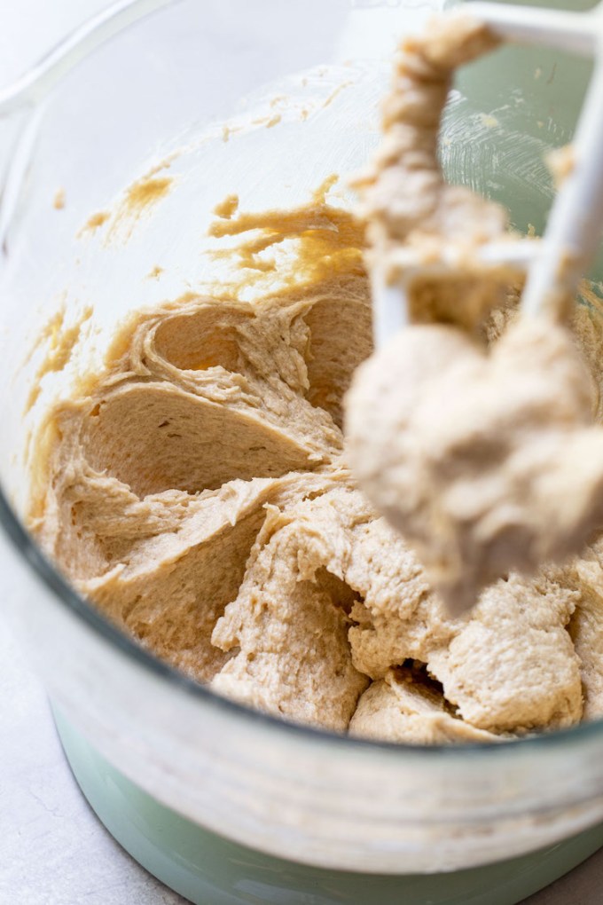 A glass mixing bowl holding the cookie batter.