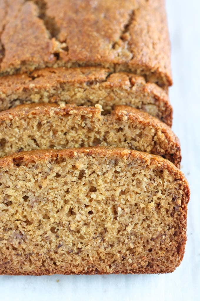 A loaf of whole wheat banana bread. The front section has been sliced. 