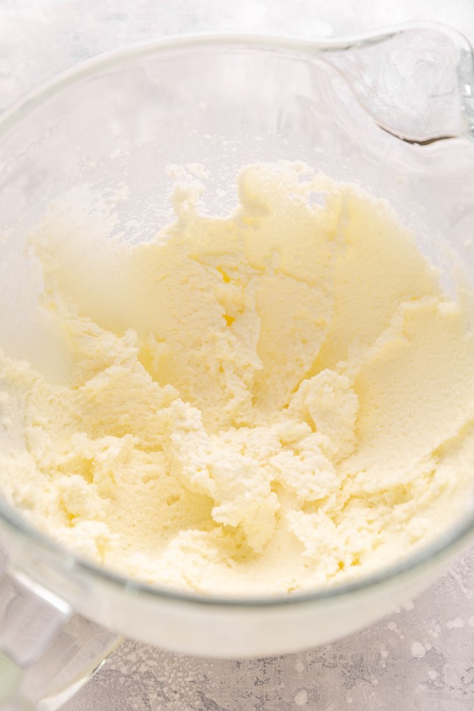 A mixing bowl with butter and sugar that's been cream until it's light and fluffy.