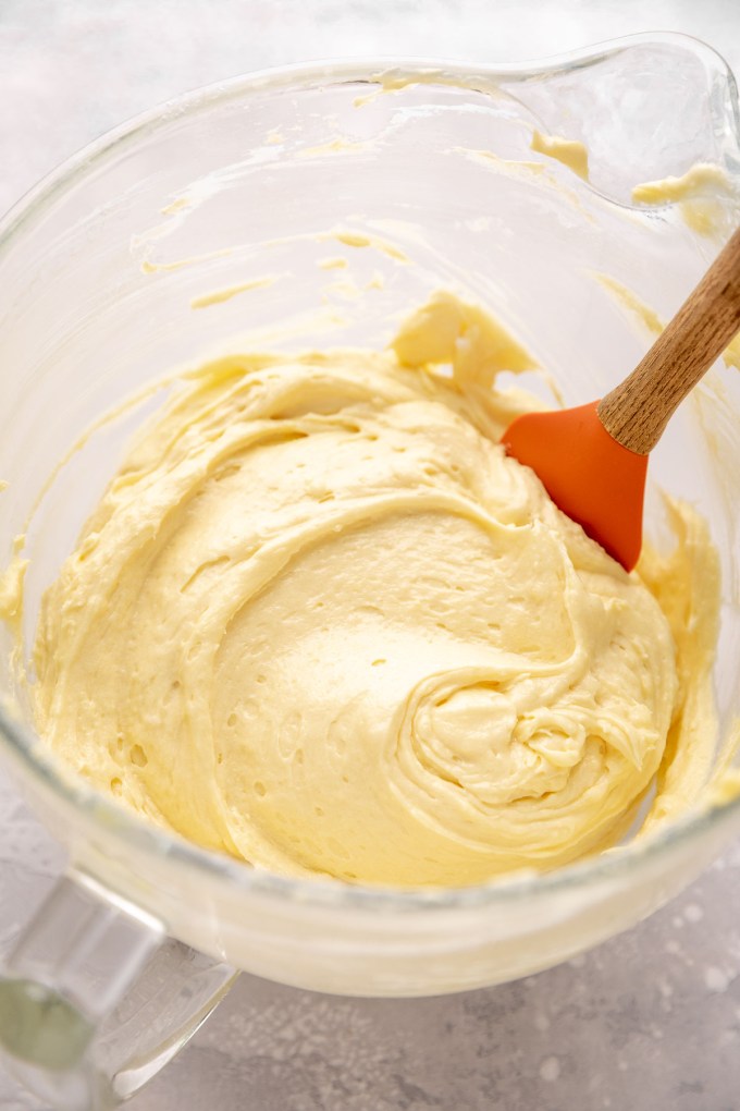 Yellow cake batter in a glass mixing bowl.